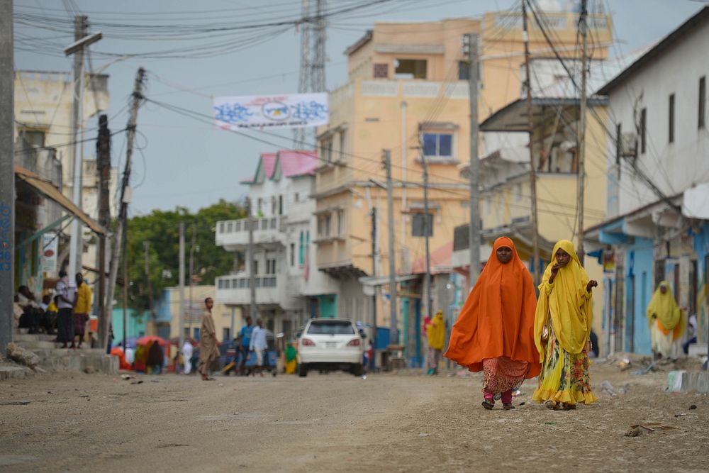 Two women dressed up for Eid el-Fitr walk through the streets in Mogadishu, Somalia, on July 6, 2016. AMISOM Photo / Tobin…