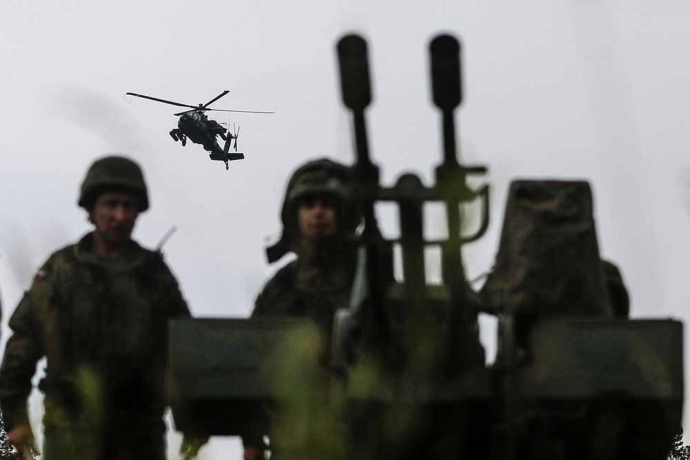 Polish army soldiers with the 15th Mechanized Brigade, post security on a heavy machine gun while receiving aerial support…