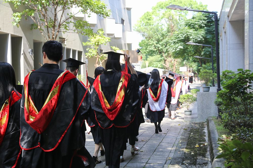 Graduating students in mortarboards. Free public domain CC0 photo.