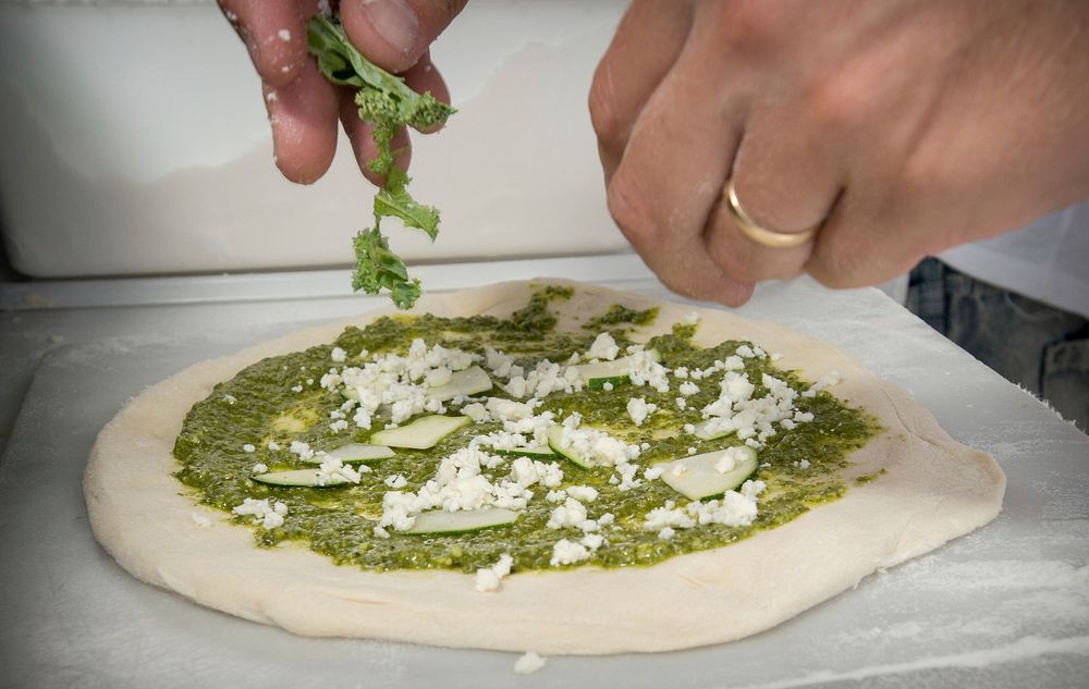 Timber Pizza Company's Jason Kellogg prepares a basil pesto, zucchini, kale and cheese based pizza during the U.S.…