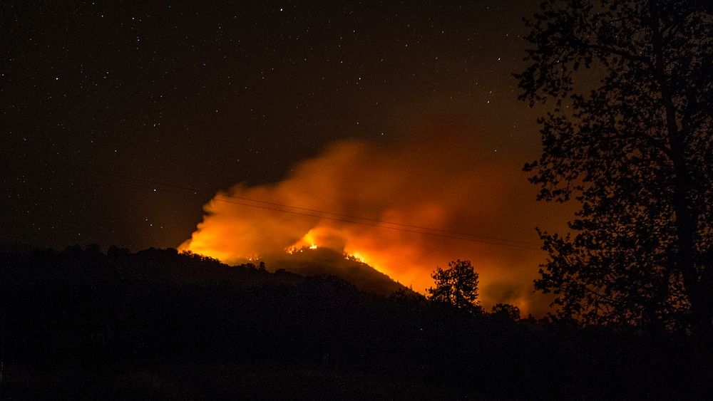 Stars shine above the Cedar Fire in and near the U.S. Department of Agriculture (USDA) Forest Service (FS) Sequoia National…