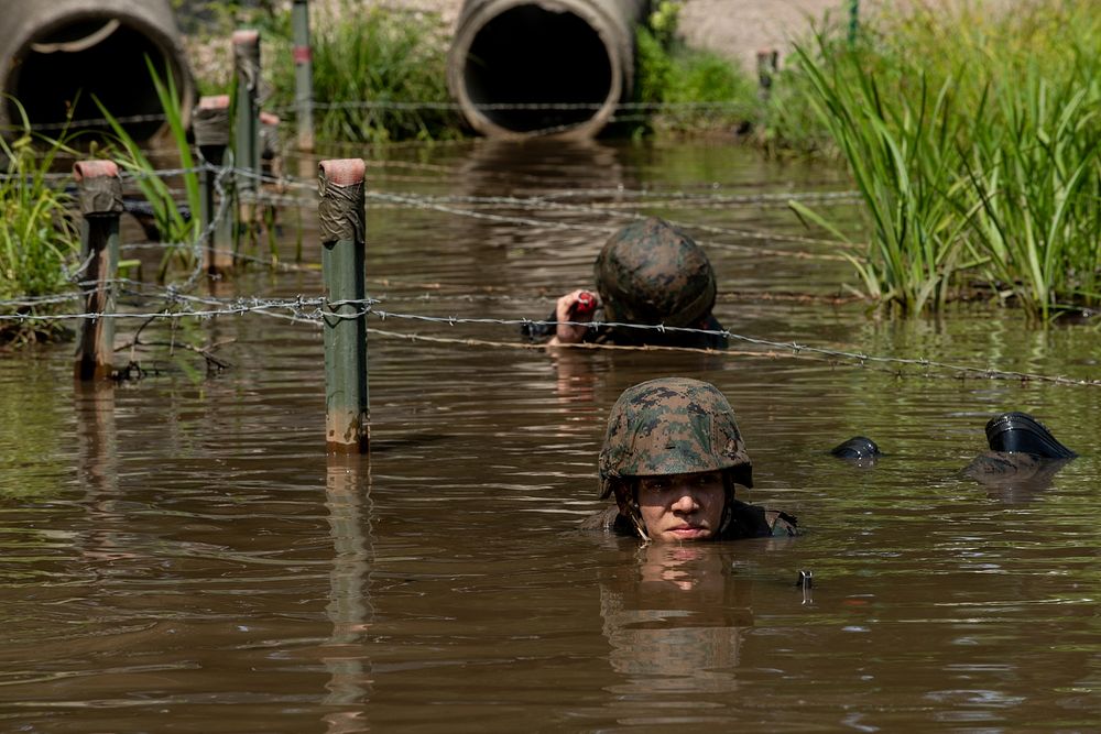 Midshipmen from the U.S. Naval Academy complete a combat course at the Marine Corps Officer Candidate School in Quantico…
