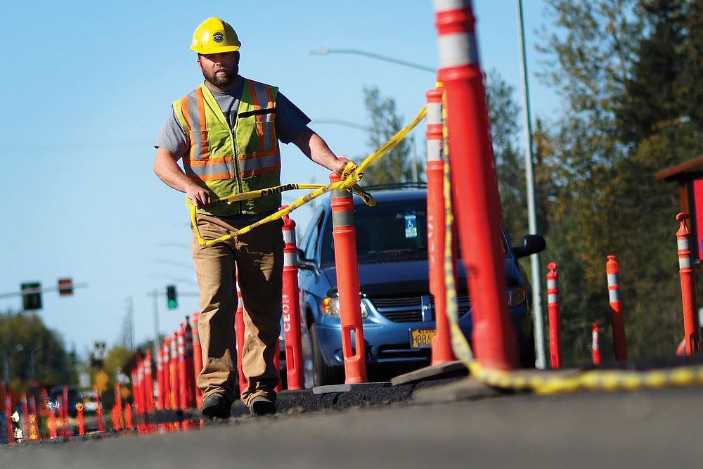 Jess Hargrave, a heavy equipment operator assigned to the 773rd Civil Engineer Squadron, lines up safety cones in a road…
