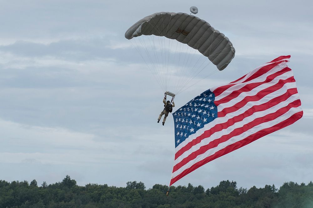Arctic Thunder Open House 2018A pararescueman with the 212th Rescue Squadron delivers the United States flag during the…