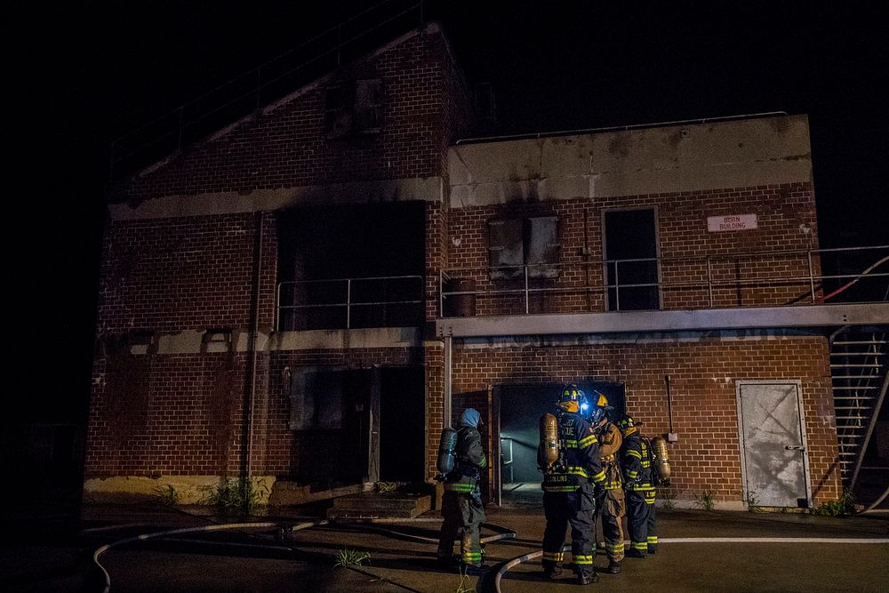 Fighterfighters prepare to enter a building during live burn training at the Anthony "Tony" Canale Training Center in Egg…