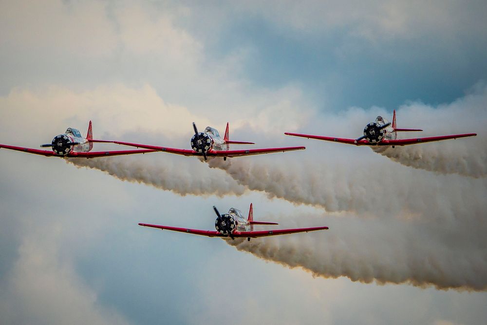 The Aeroshell Aerobatic Team (T-6 Texans) prepare for take off at the EAA AirVenture Oshkosh, Wisconsin.USDA Photo by…