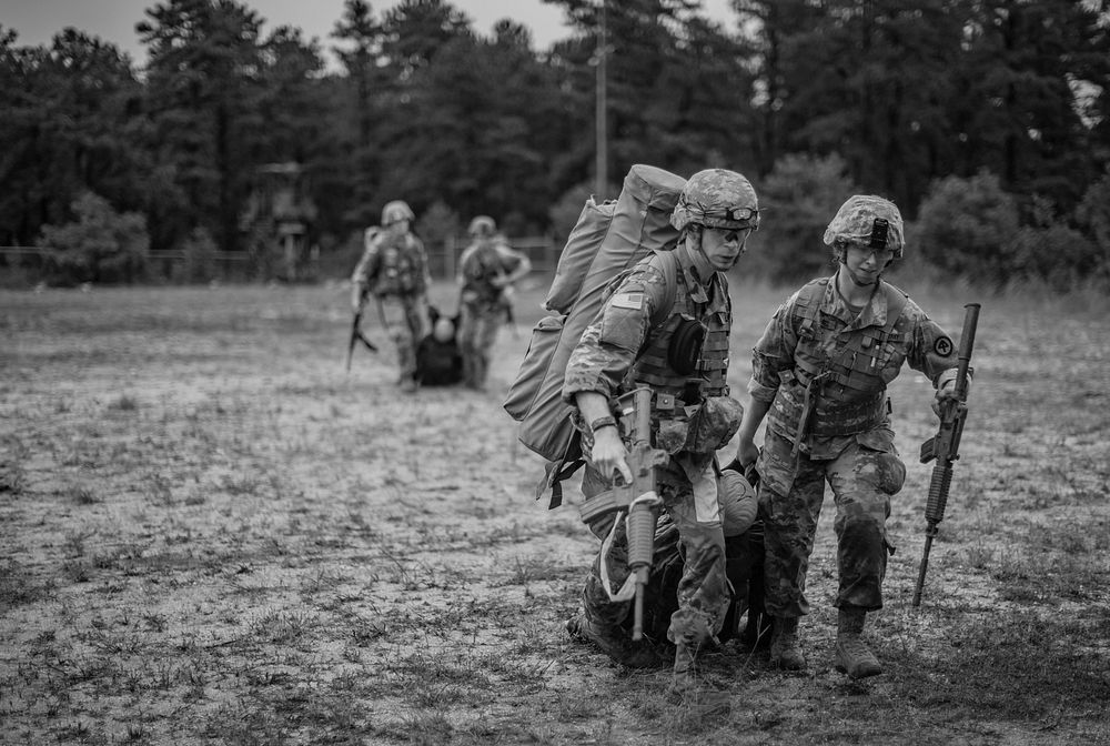 New Jersey Army National Guard Soldiers carry a Rescue Randy manikin during a tactical trauma care course on Joint Base…