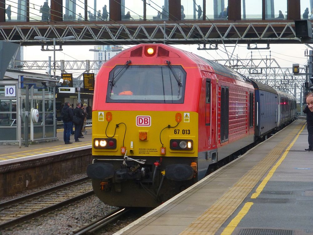 Diesel locomotive Class 67 013 hauling the first London Crossrail Line 1 (Elizabeth) Class 345 train past platform 10a at…