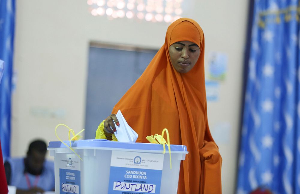 A delegate casts her vote during the electoral process to choose members of the Lower House of the Federal Parliament in…