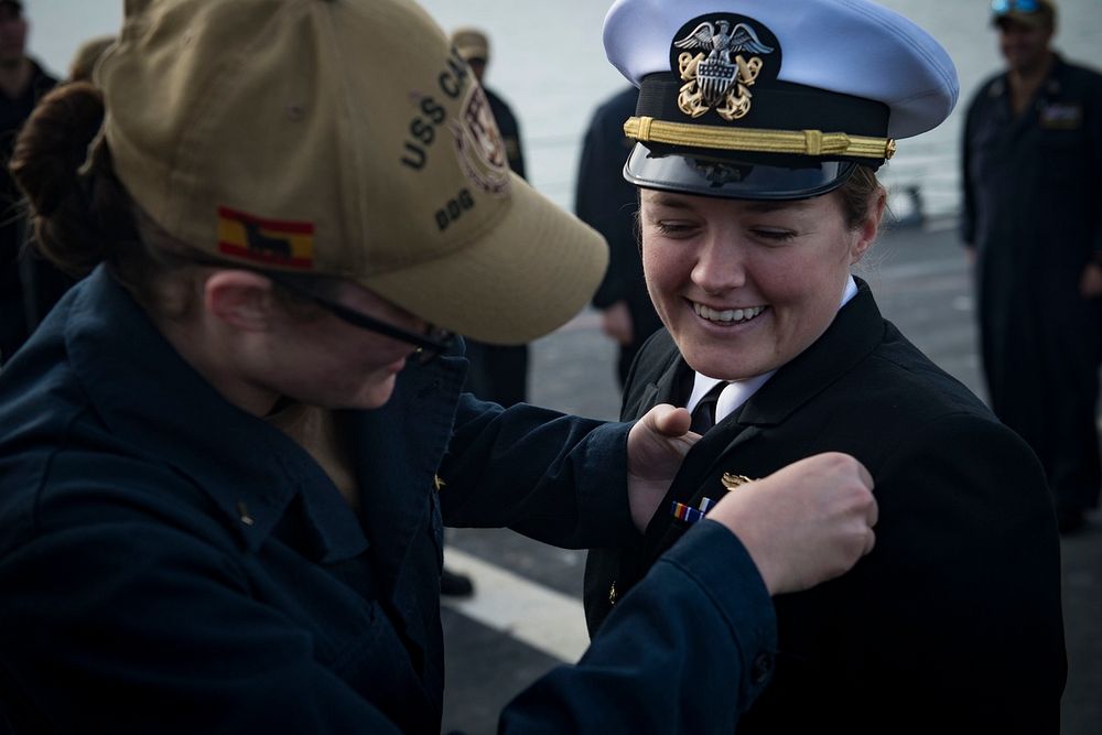 MEDITERRANEAN SEA (Nov. 16, 2018) Ensign Laura Palombella presents Ensign Bridget Kennedy with a surface warfare officer pin…
