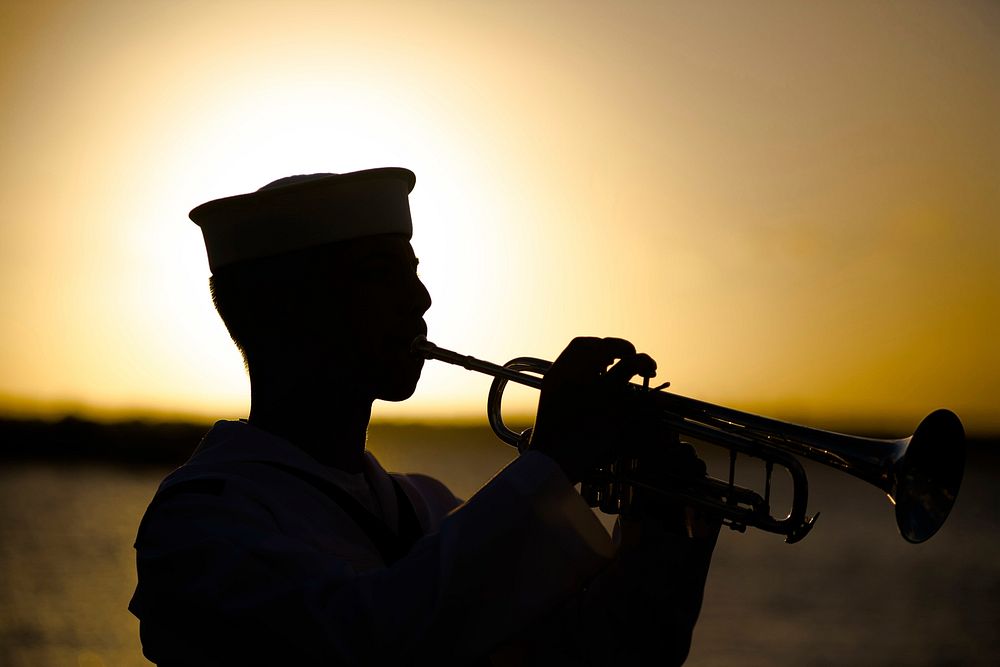 A U.S. Navy Musician Seaman plays 'Taps' during the USS Utah Memorial Sunset Ceremony at Pearl Harbor, Hawaii, Dec. 7, 2018.