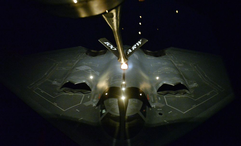 A KC-135 Strantotanker from the 100th Air Refueling Wing refuels a B-2 Spirit from the 509th Bomb Wing in the late hours of…
