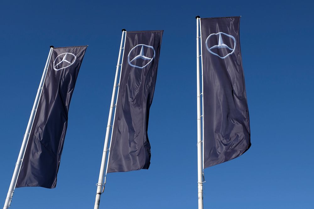 Mercedes Benz flag against a blue sky, location unknown, date unknown.