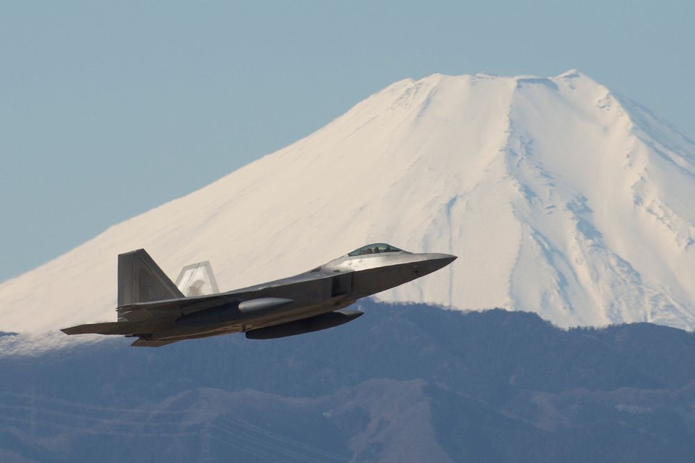 A U.S. Air Force F-22 Raptor from the 90th Fighter Squadron at Joint Base Elmendorf-Richardson, takes off at Yokota Air…