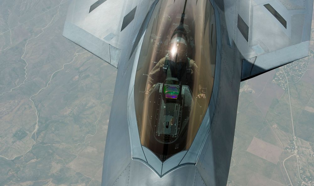 A U.S. Air Force F-22 Raptor pilot maneuvers his plane into position with a KC-135 Stratotanker assigned to the 340th…