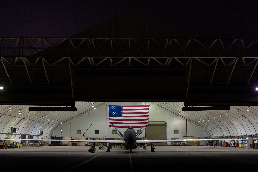 U.S. Air Force EQ-4 Global Hawk unmanned aerial vehicles assigned to the 380th Air Expeditionary Wing await routine…