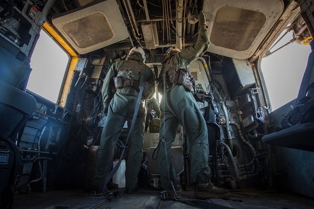 U.S. Marine Corps Lance Cpl. Mason DiNicola, left, and Cpl. Bradley Lauer, crew chiefs with Marine Heavy Helicopter Squadron…