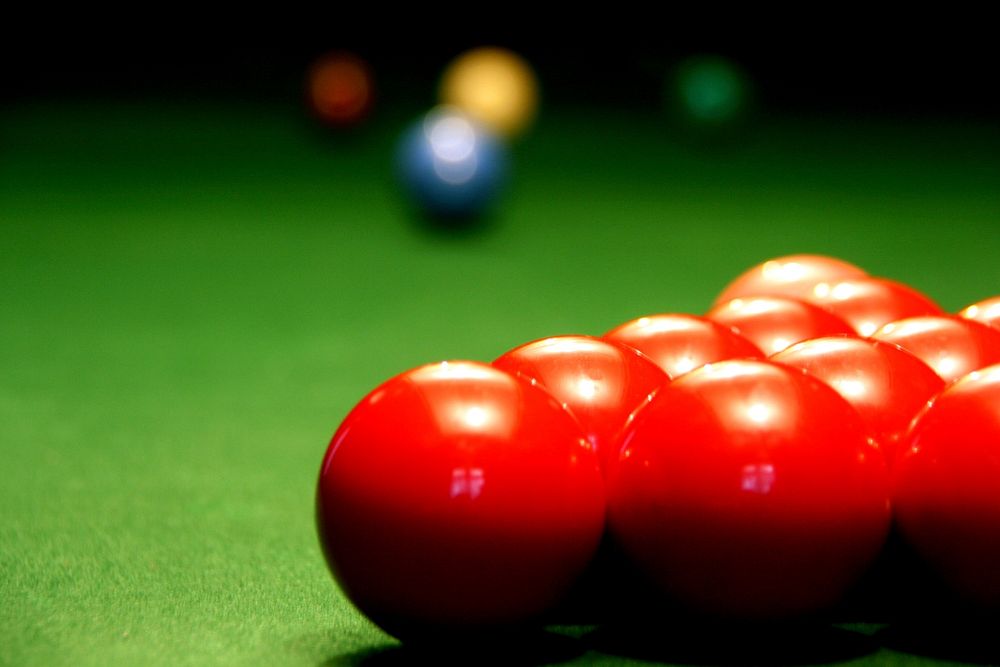 Close up red pool balls on pool table. Original public domain image from Flickr