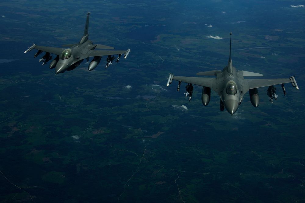 Two U.S. Air Force F-16 Fighting Falcon aircraft with the 510th Fighter Squadron fly over Latvia June 7, 2017, during a…