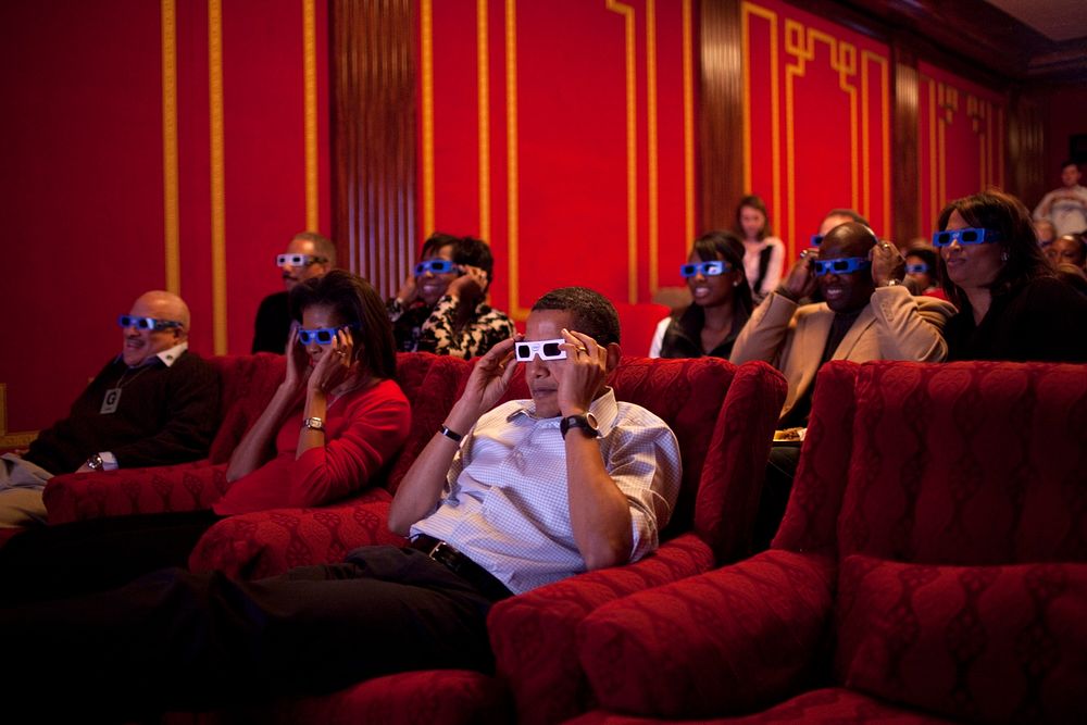 President Barack Obama and First Lady Michelle Obama wear 3-D glasses while watching a TV commercial during Super Bowl 43…