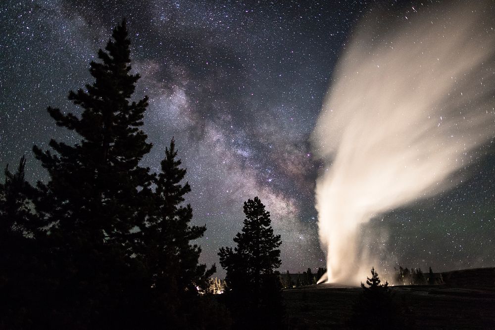 Old Faithful erupts under a clear summer sky. Original public domain image from Flickr