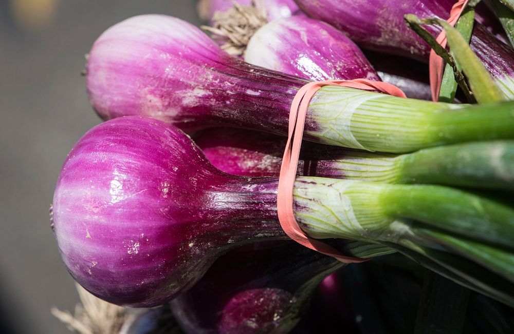 Red spring onions on sale by vendors at the U.S. Department of Agriculture (USDA) Farmers Market in Washington, D.C., on May…