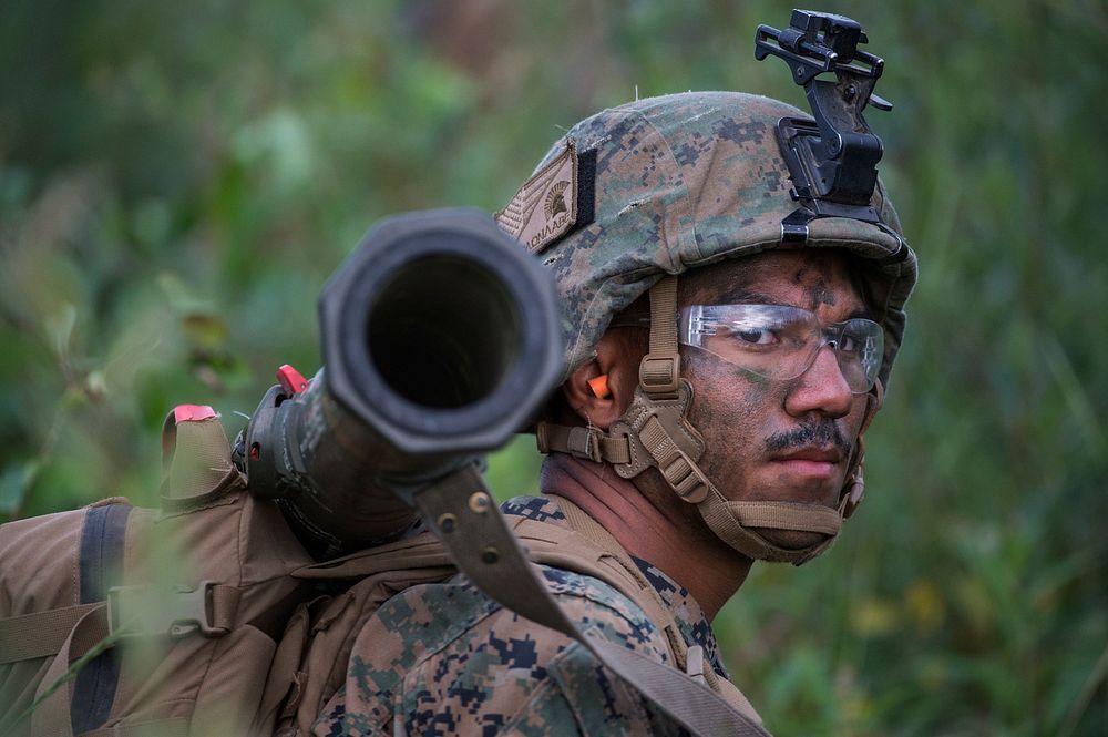 A U.S. Marine assigned to 2nd Battalion, 23rd Marine Regiment, 4th Marine Division, waits to ambush simulated enemy…