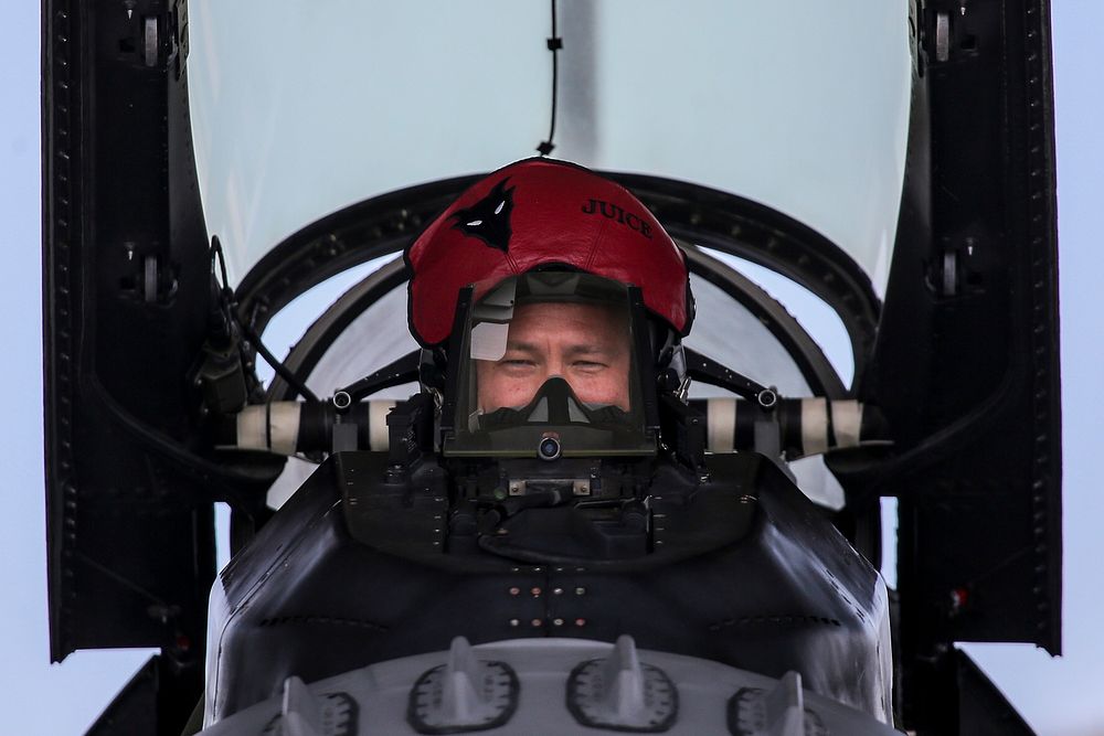 U.S. Air Force Maj. Alex Scott, an F-16 pilot from the 119th Fighter Squadron, readies himself in the cockpit of his…