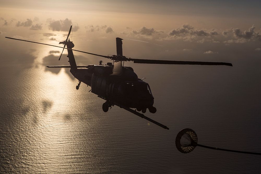 An HH-60G Pave Hawk refuels from an HC-130P/N King enroute to rescue two German citizens in distress at sea July 7, 2017 and…
