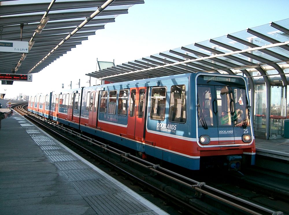 A London Docklands Light Railway train in original livery headed by B90 unit No.25 calls at Royal Albert station.