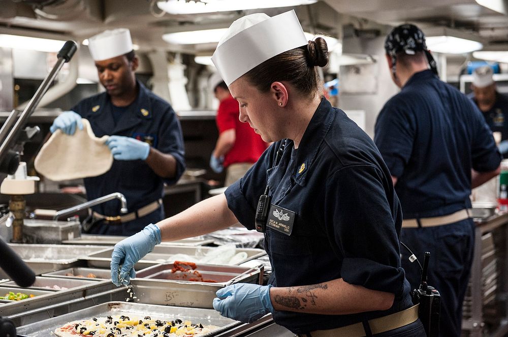 MEDITERRANEAN SEA (July 15, 2017) Chief Electronics Technician Kayla Jaramillo puts toppings on her handmade pizza in the…