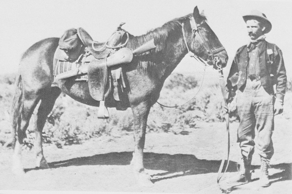 Forest Service Ranger poses with his horse 1900's. Original public domain image from Flickr