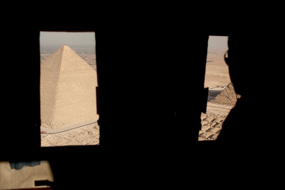President Barack Obama looks out the window of Marine One as they leave the Pyramids of Giza and Sphinx in Egypt, June 4…
