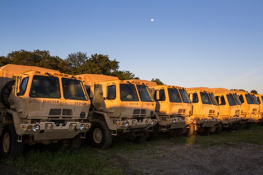 The moon sets over light medium tactical vehicles with the 253rd Transportation Company at Cape May Courthouse, N.J., Sept.…