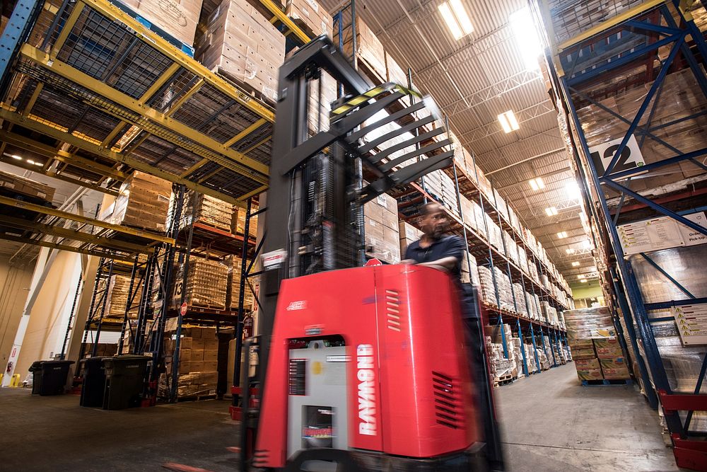 Pallets of USDA Emergency Food Assistance Program (TEFAP) commodities wait on the Houston Food Bank commodity warehouse…