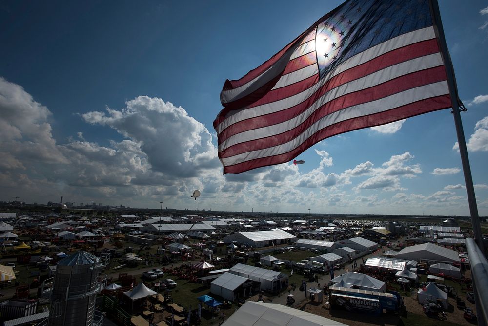 Grain bins, structures and other equipment of many kinds and designs hold U.S. national flags high above the Farm Progress…