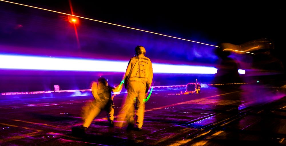 ARABIAN GULF (Aug. 12, 2017) A jet blasts off the flight deck as Sailors conduct night flight operations aboard the aircraft…