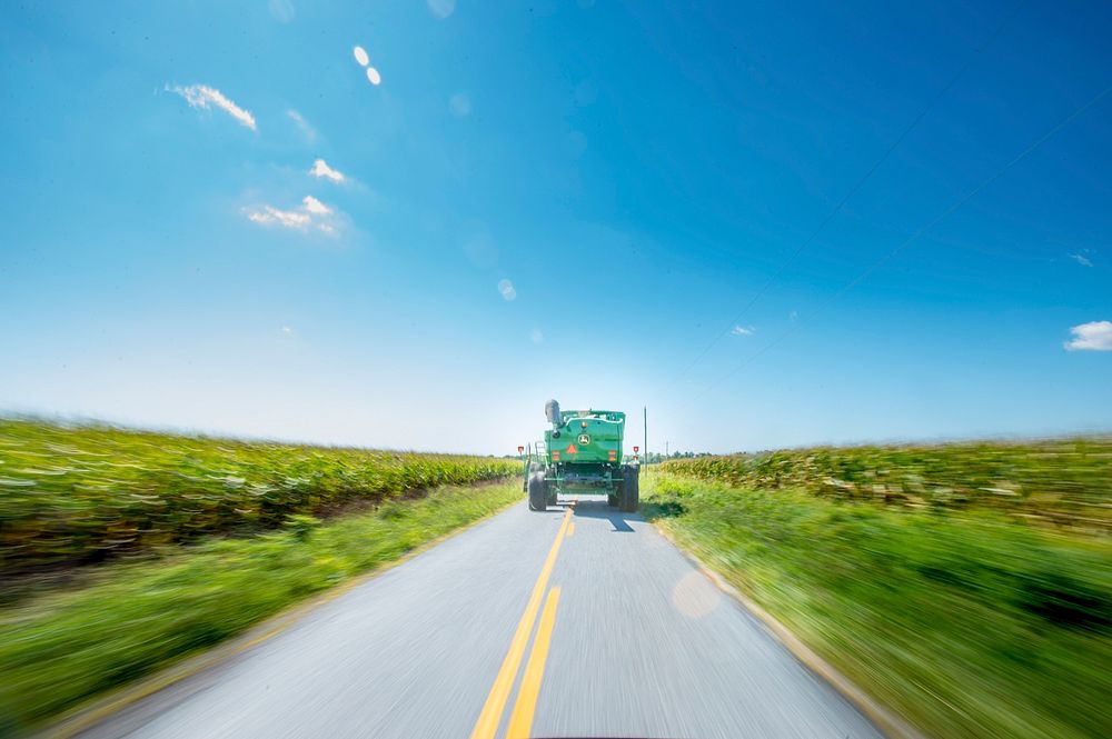 Navy-veteran Lenny Evans Miles, Jr. navigates the combine down the road to one of the several family fields of Bluestem…