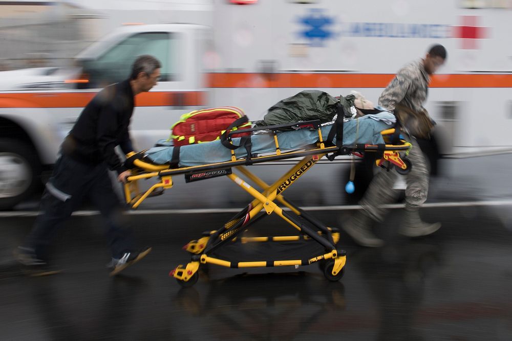 Emergency responders from the 374th Medical Group transport a simulated victim during an active shooter exercise, Aug. 16…