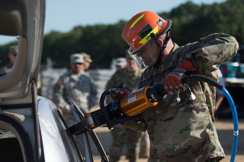 One of the many 372nd Engineer Brigade firefighters tests a piece of extrication equipment on a scrap car during the 372nd…