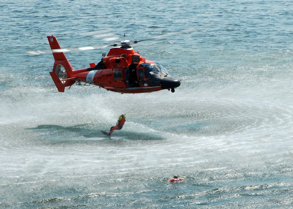 U.S. Coast Guardsmen with a search and rescue team perform a search and rescue demonstration during the 60th annual Seattle…