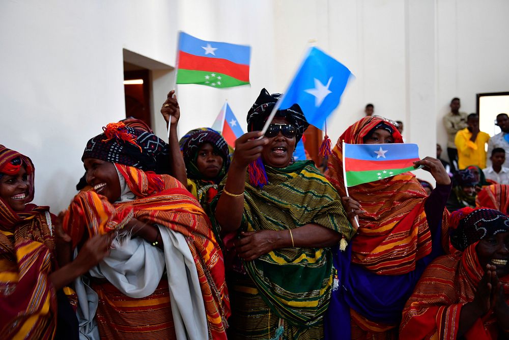 Women wave flags to welcome the Special Representative of the Chairperson of the African Union Commission (SRCC) for…