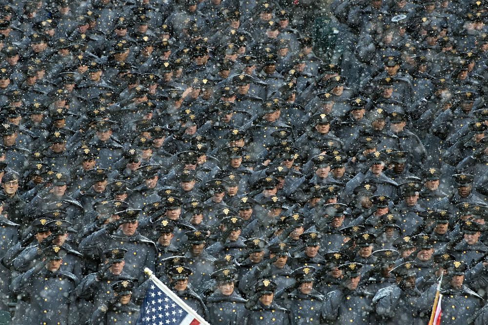 United States Military Academy cadets salute during the National Anthem at the annual Army-Navy Game in Philadelphia Dec. 9…