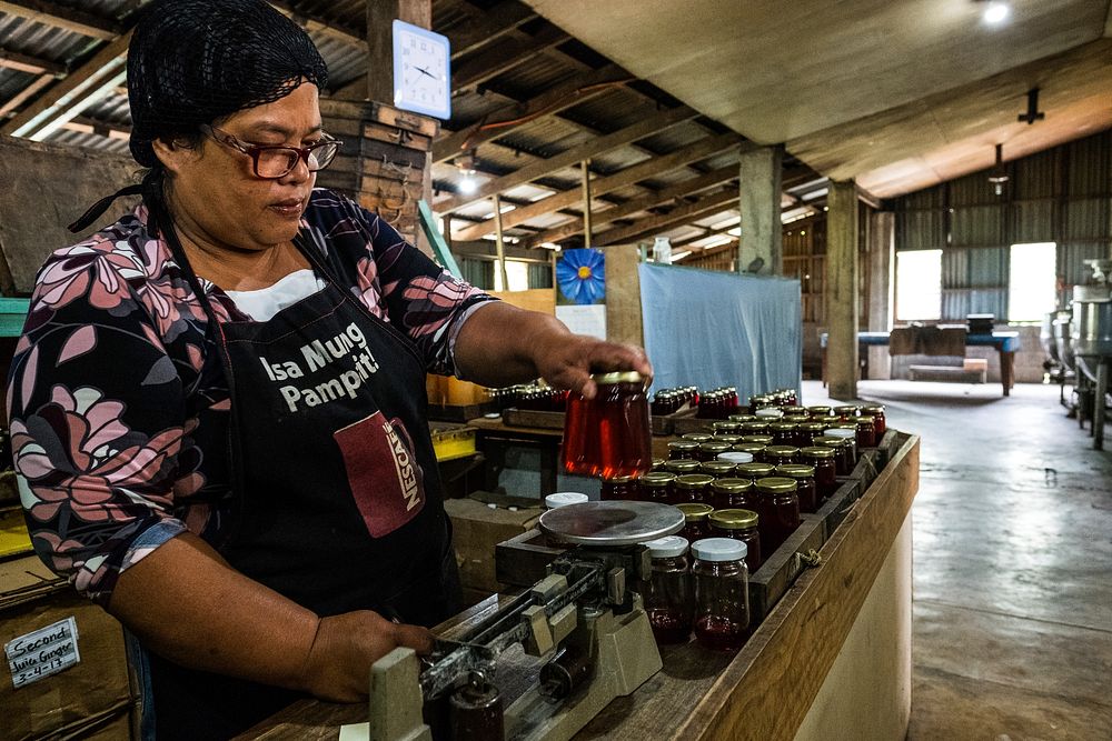 Woman packing raw honey products, Imugan, Nueva Vizcaya, Philippines, July 2017.