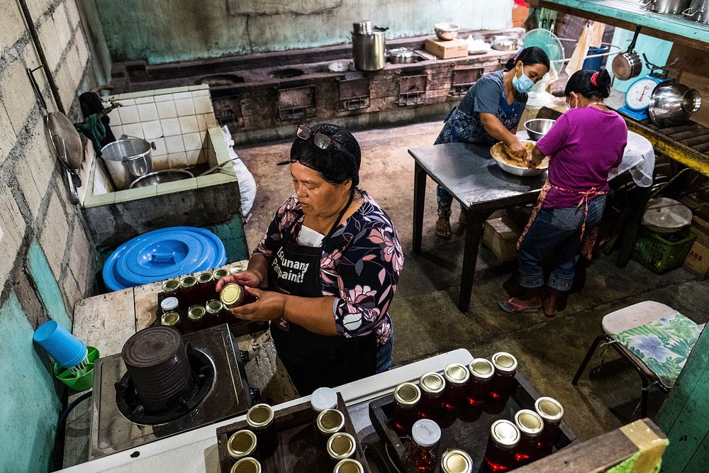 Woman packing raw honey products, Imugan, Nueva Vizcaya, Philippines, July 2017.