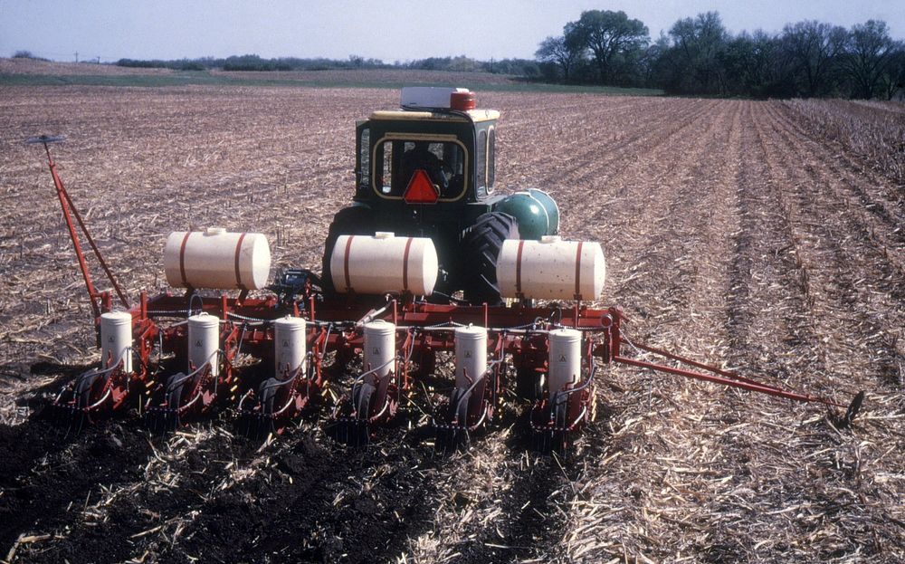 Tractor spraying field. Original public domain image from Flickr