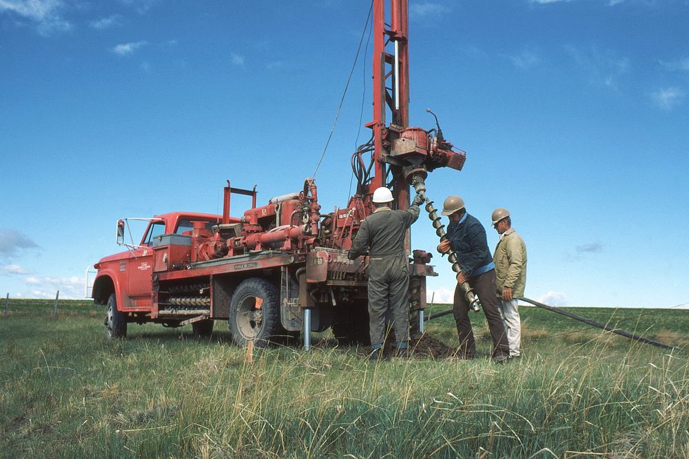 People changing drill bit on drilling rig, May 1976. Original public domain image from Flickr