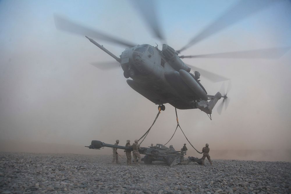 U.S. Marines with a helicopter support team from Combat Logistics Battalion 8 attach an M777A2 lightweight howitzer to a CH…
