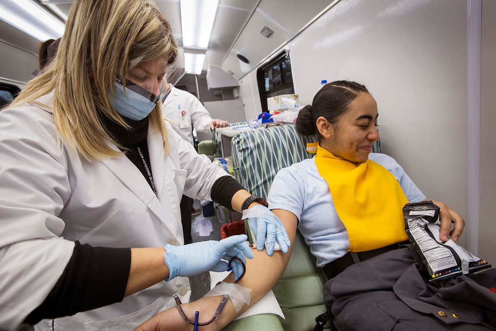 Phlebotomist Sandra Rodriguez, left, Miller Keystone Blood Center, Ewing, N.J., removes a blood donation needle from Cadet…