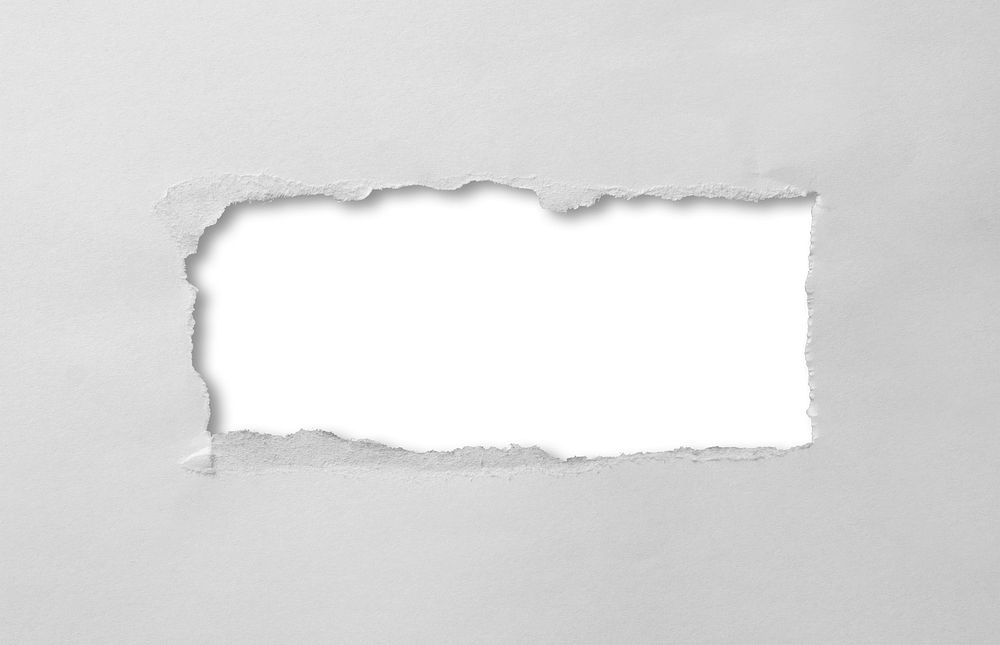 A hole torn through paper on white background